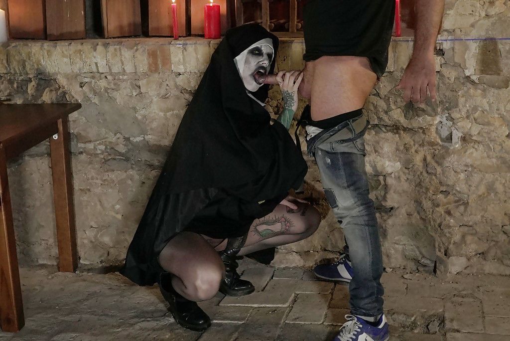 Europeu feminino chegando pregado enquanto vestindo assustador freira traje