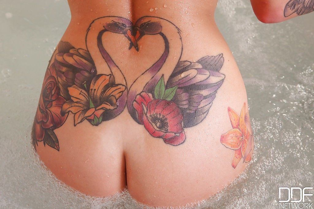Tattooed solo girl Daniella Mae releasing big tits from bikini in bathroom