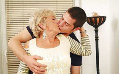 Lustful granny with massive jugs gets her hairy cunt pleased by a younger lad
