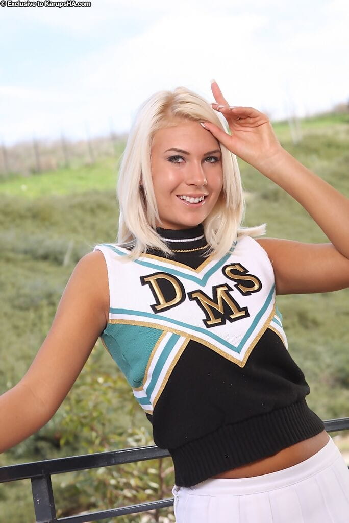 Blonde cheerleader Danica slips off her uniform for her nude premiere