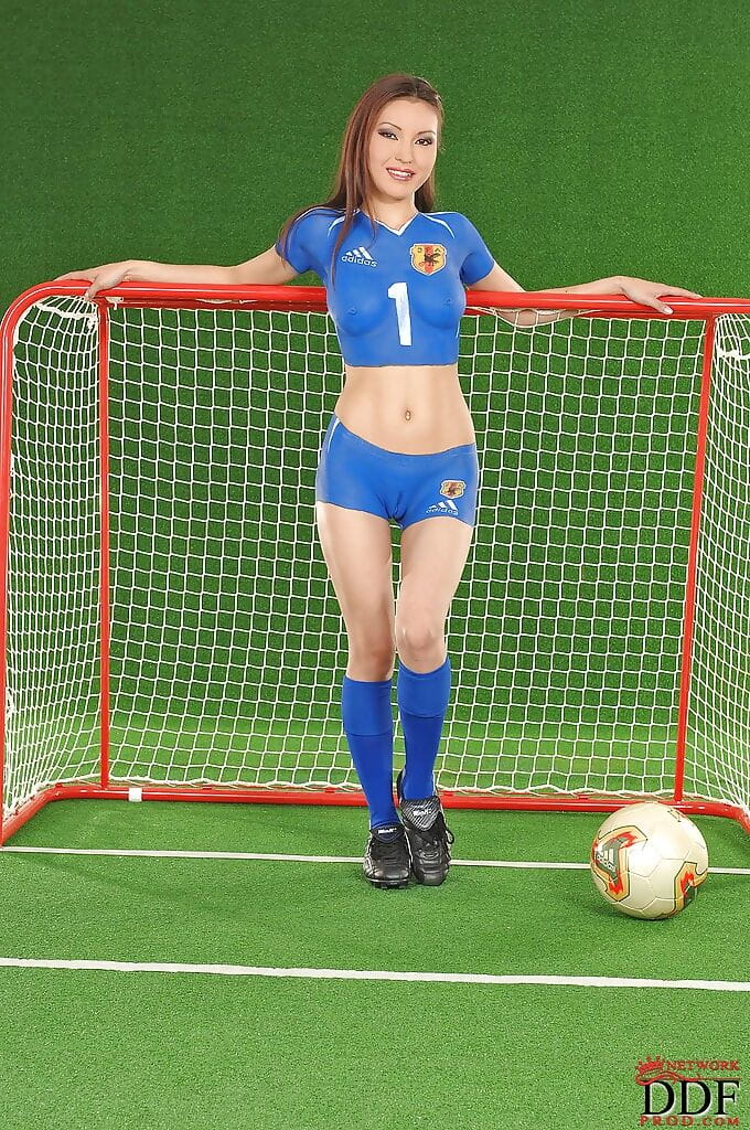 Foxy asian teen with hot ass poses in body painted soccer outfit