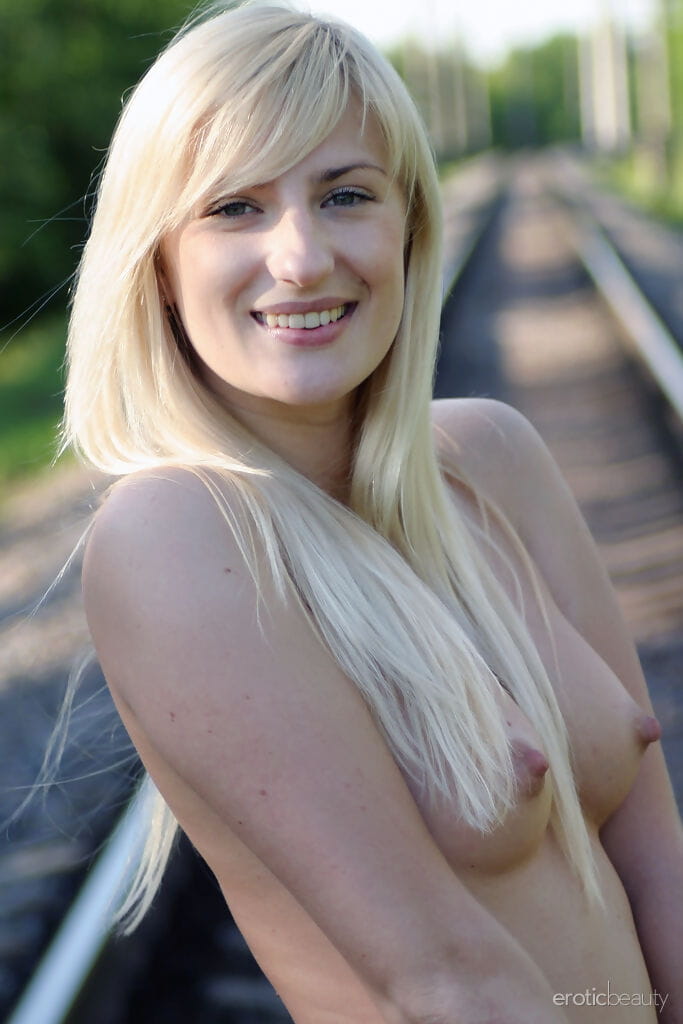 Langbenige Blond Margo H Strips naar enkel riem hakken op spoorwegen tracks