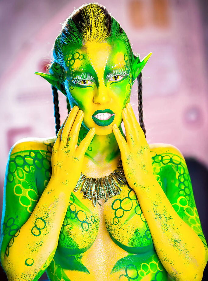 Kinky cosplay chick Tiffany Doll posing in body paint uniform and spreading