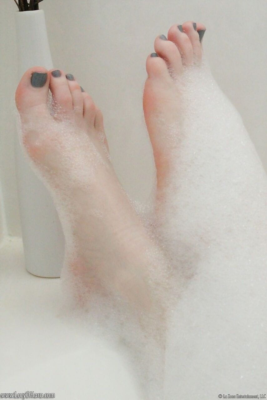 Pale redhead Lucy OHara lathering up her sweet perky tits & toes in the shower