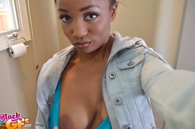 Charming ebony babe with big natural boobs plays with her tits in a bathroom