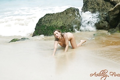 Blonde beach babe Ashley Fires modeling topless in bikini bottoms